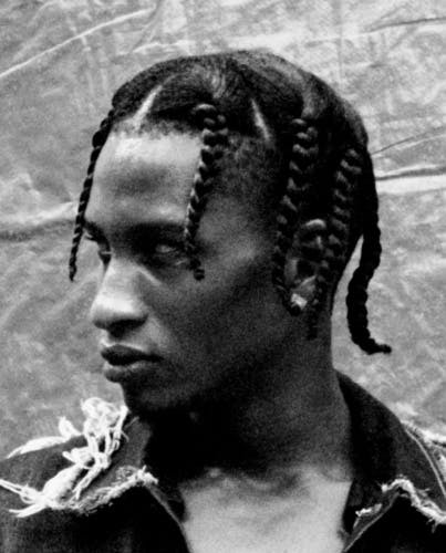 Black and white portrait photo by Kwabena Sekyi Appiah-nti of a person with braided hair and a jewelled stud earring looking to the side
