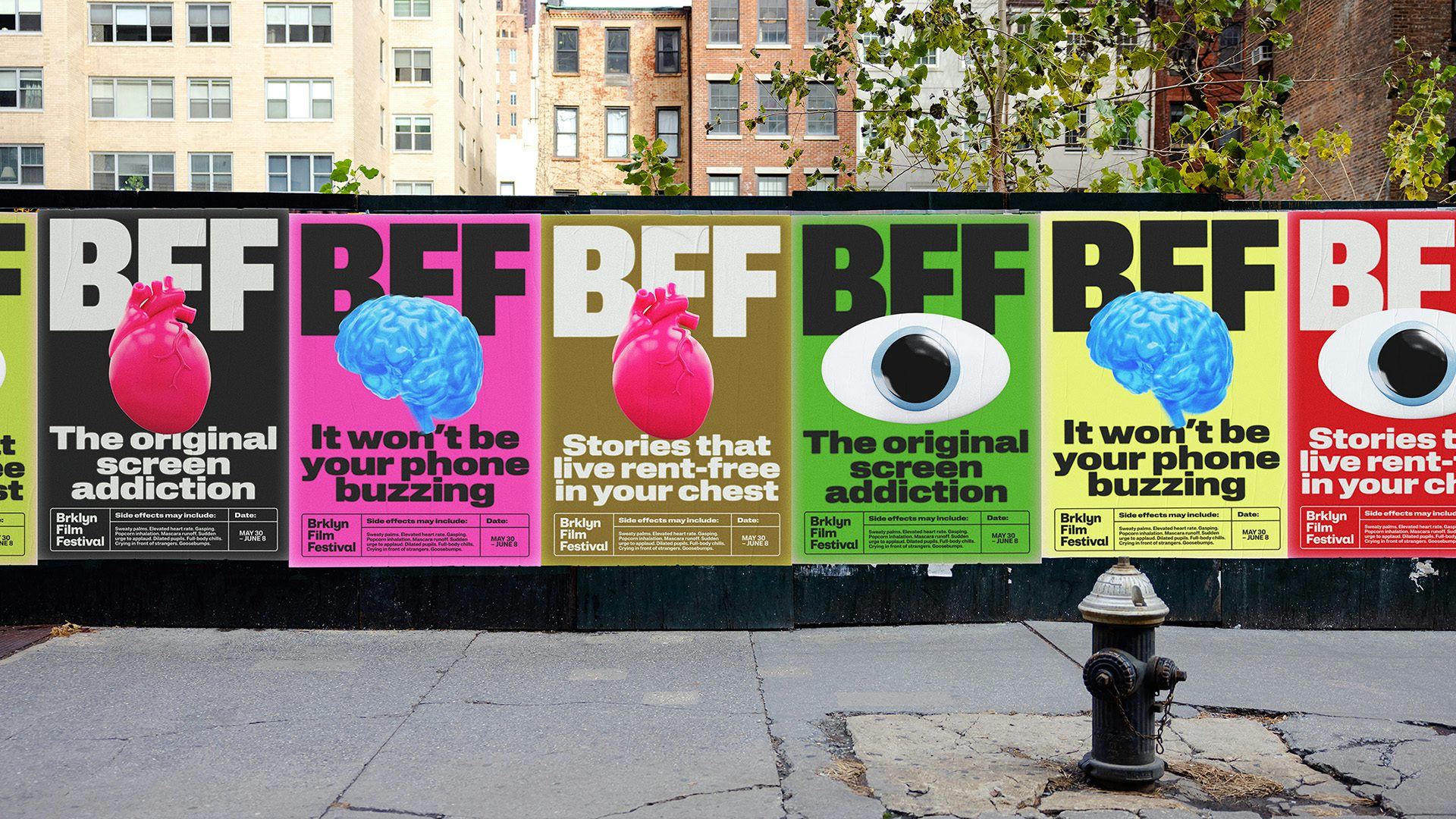 Row of bright pink, yellow and black posters for Brooklyn Film Festival branding featuring large 3D icons of an eye and a brain and featuring the tagline 'Welcome to good screen time'