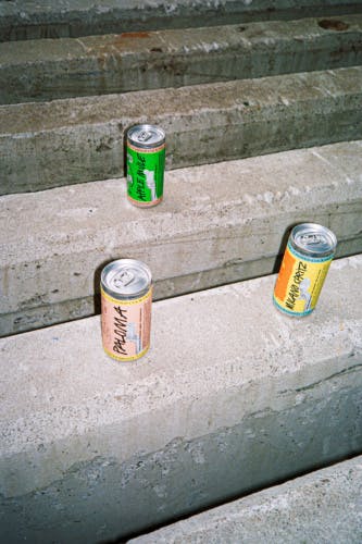 Three drinks cans on concrete steps