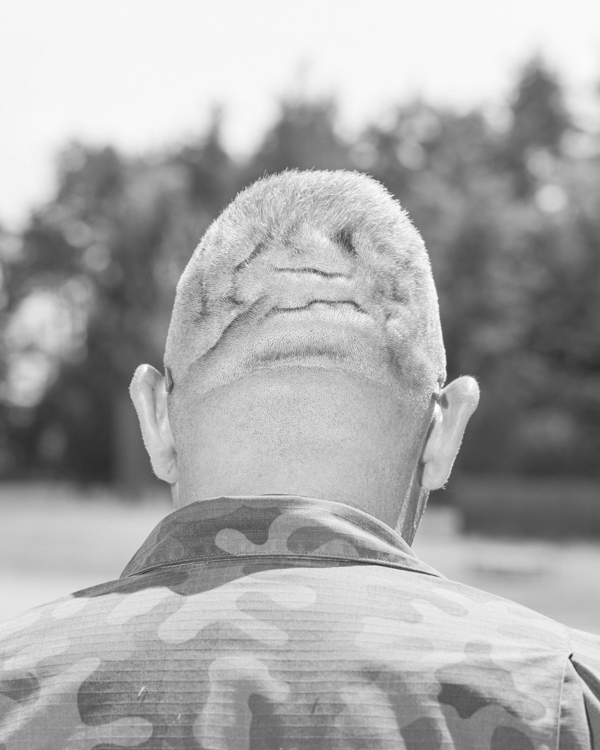 Black and white photo by Karol Szymkowiak showing the wrinkled head of a person wearing a camo jacket