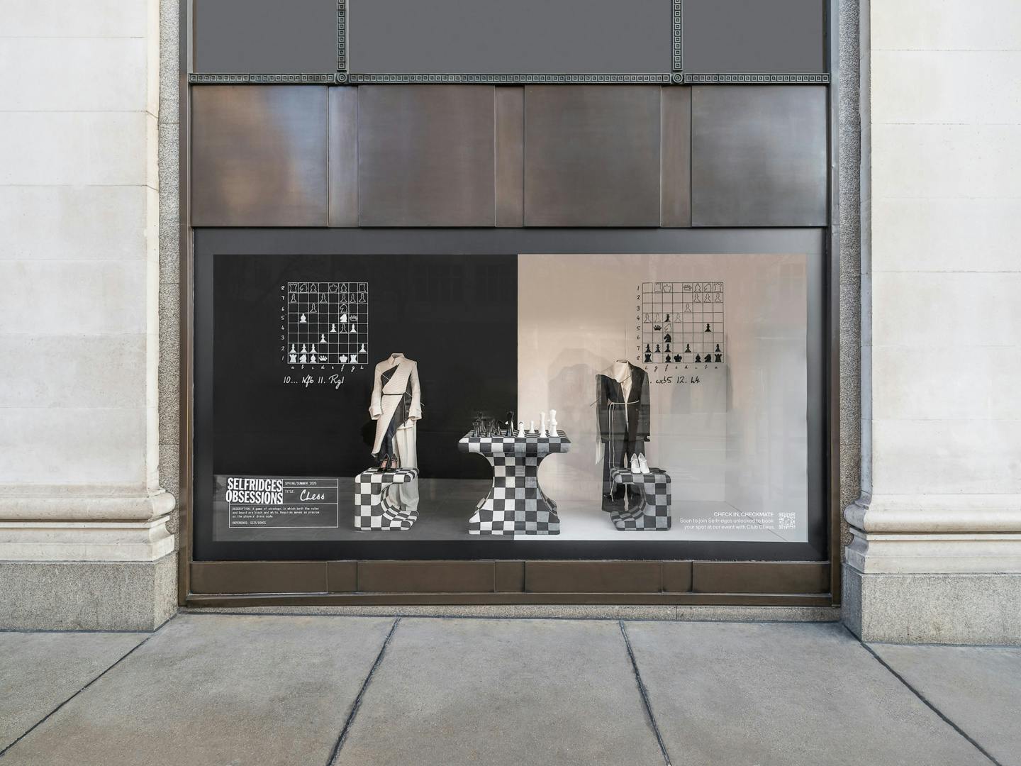 Selfridges store window featuring an installation with a chess table and chessboard inspired seating and clothing on mannequins