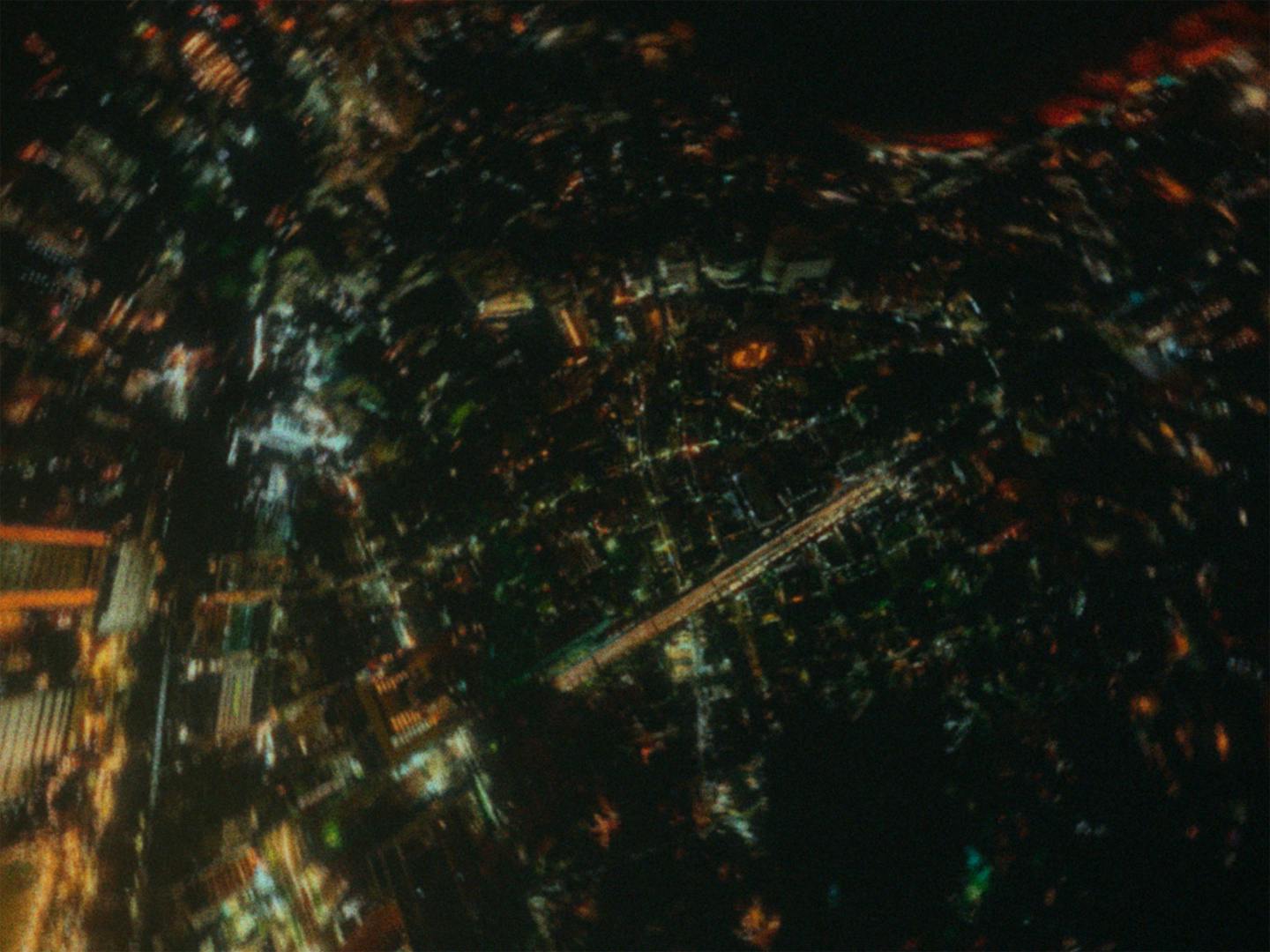 Still from Squid's music video Building 650 of an aerial view of Tokyo at night