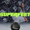 A person wearing shoes featuring an overlaid graphic showing the sole technology, and a bright green Superfeet wordmark over the top