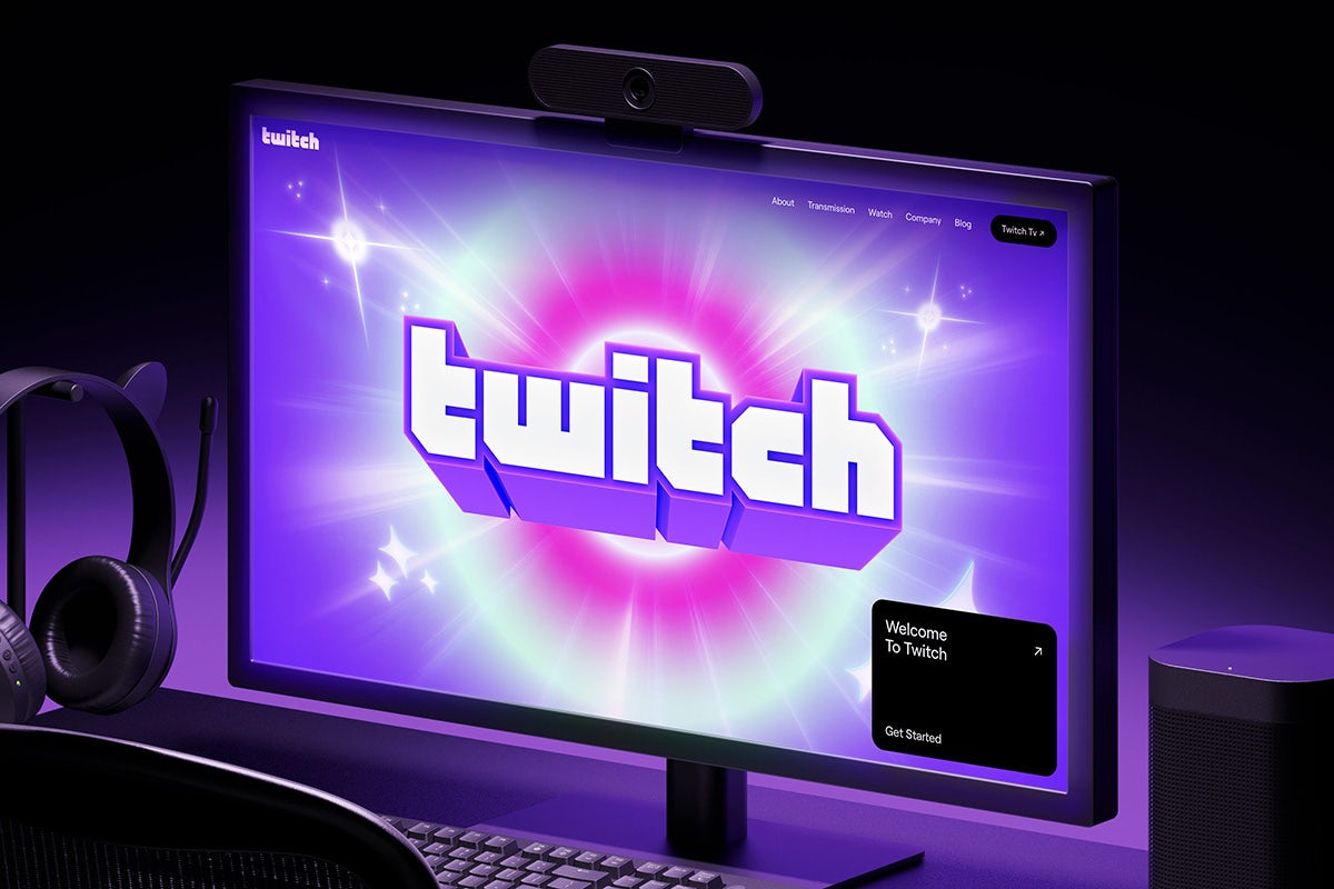 Desktop computer showing a graphic for Twitch featuring the brand's retro geometric wordmark against a pink and purple sparkly background