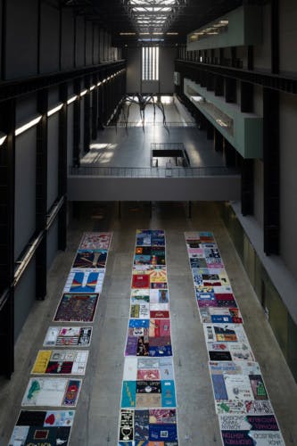UK AIDS Memorial Quilt laid out in three long rows in Tate Modern's Turbine Hall